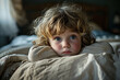 young girl kid sitting on bed with sad expression