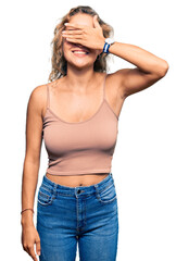 Wall Mural - Beautiful caucasian woman wearing casual clothes smiling and laughing with hand on face covering eyes for surprise. blind concept.