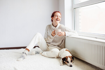 Wall Mural - Young Woman Drinking hot coffee at white room