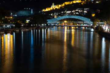 Wall Mural - Panoramic landscape of downtown Tbilisi at night with church and bridge of peace