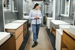 © Serhii - Young woman choosing new bathroom furniture at the plumbing shop with lots of sanitary goods