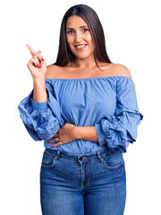 Canvas Print - Young beautiful brunette woman wearing casual t-shirt smiling happy pointing with hand and finger to the side