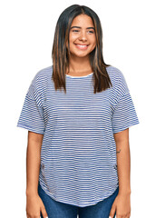 Poster - Young latin girl wearing casual clothes looking away to side with smile on face, natural expression. laughing confident.