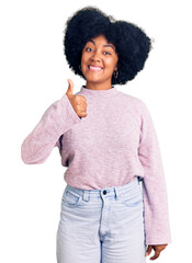 Poster - Young african american girl wearing casual clothes smiling doing phone gesture with hand and fingers like talking on the telephone. communicating concepts.