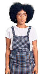 Poster - Young african american girl wearing casual clothes making fish face with lips, crazy and comical gesture. funny expression.