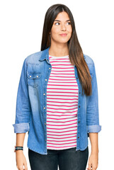 Sticker - Young brunette woman wearing casual clothes smiling looking to the side and staring away thinking.