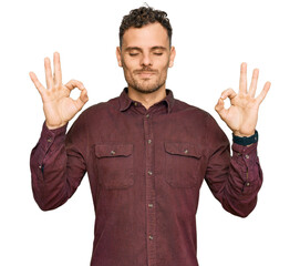 Sticker - Young hispanic man wearing casual clothes relaxed and smiling with eyes closed doing meditation gesture with fingers. yoga concept.