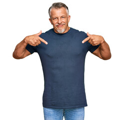 Wall Mural - Middle age grey-haired man wearing casual clothes looking confident with smile on face, pointing oneself with fingers proud and happy.