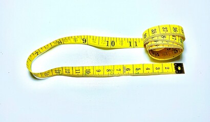 Yellow measuring tape isolated on white background. The concept of diet and healthy lifestyle.