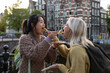 © ReeldealHD images - Female tourists eating local food in Amsterdam