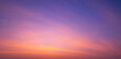 Sunset sky background with beautiful pink sunrise clouds on colorful dramatic twilight sky in panoramic view 