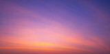 Fototapeta  - Sunset sky background with beautiful pink sunrise clouds on colorful dramatic twilight sky in panoramic view 