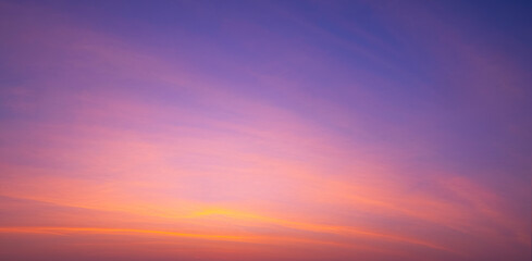 sunset sky background with beautiful pink sunrise clouds on colorful dramatic twilight sky in panora
