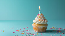 Birthday Cupcake With Candle On Light Blue Table Against Blurred Blue Background. Party Banner With Copy Space For Festive Celebrations And Happy Occasions.
