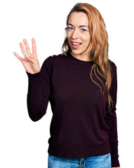 Wall Mural - Young caucasian woman wearing casual clothes showing and pointing up with fingers number four while smiling confident and happy.