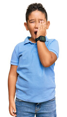 Poster - Little boy hispanic kid wearing casual clothes yawning tired covering half face, eye and mouth with hand. face hurts in pain.