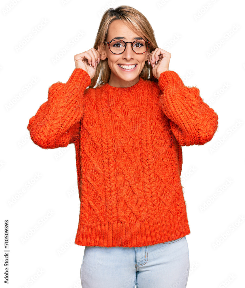 Beautiful blonde woman wearing casual clothes and glasses smiling pulling ears with fingers, funny gesture. audition problem