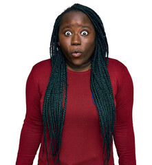 Wall Mural - Young black woman with braids wearing casual clothes scared and amazed with open mouth for surprise, disbelief face
