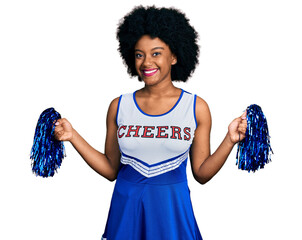 Wall Mural - Young african american woman wearing cheerleader uniform using pompom smiling with a happy and cool smile on face. showing teeth.