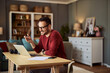 © Jelena - A happy adult freelance man on a video call and negotiating with a client on a laptop.