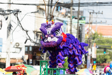 Wall Mural - Chinese lion dance show on street in the Chinese New Year festival.Chinese lion costume used during Chinese New Year celebration in China town.Holidays and celebrations concept. Selective focus.