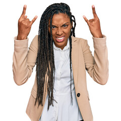 Wall Mural - African american woman wearing business jacket shouting with crazy expression doing rock symbol with hands up. music star. heavy music concept.