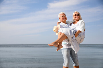 Sticker - Mature couple spending time together near sea