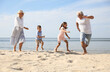 © New Africa - Cute little children with grandparents spending time together on sea beach