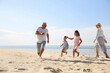 © New Africa - Cute little children with grandparents spending time together on sea beach