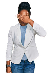 Wall Mural - Young african american woman wearing business clothes covering eyes with hand, looking serious and sad. sightless, hiding and rejection concept