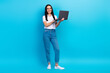 © deagreez - Full length photo of smart clever girl dressed white shirt typing emails modern gadget isolated blue color background