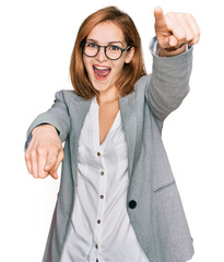 Wall Mural - Young caucasian woman wearing business style and glasses pointing to you and the camera with fingers, smiling positive and cheerful