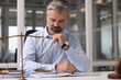 © New Africa - Portrait of handsome lawyer working at table in office