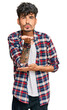 © Krakenimages.com - Young hispanic man wearing casual clothes looking at the camera blowing a kiss with hand on air being lovely and sexy. love expression.