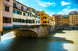 Golden bridge across Arno river in Florence