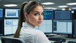 © SR07XC3 - Close-up of Woman IT Technician in Control Room Managing Multiple Screens.