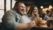 Happy obese couple sitting in a fast food restaurant. Smiling fat couple eating burgers in a fast food place. Overweight people happily eat junk food in a restaurant. Smiling fat couple.