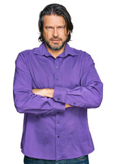 Poster - Middle age handsome man wearing business shirt skeptic and nervous, disapproving expression on face with crossed arms. negative person.