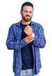 © Krakenimages.com - Young hispanic man wearing casual clothes suffering pain on hands and fingers, arthritis inflammation