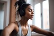 cropped shot of a sporty young woman listening to music while exercising at home