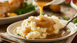 Gravy poured into mashed potatoes