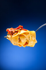 Wall Mural - Tagliatelle with clams on a red background