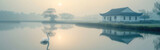 Fototapeta Pomosty - swan in a foggy lake at sunrise, panoramic view