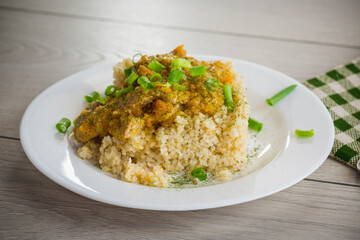 Wall Mural - cooked bulgur with meat sauce and vegetables in a plate