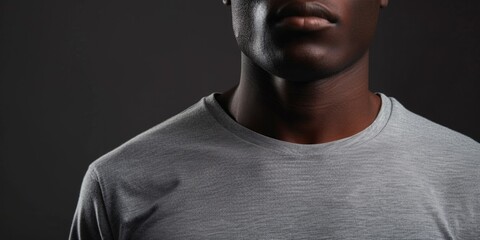 Poster - A man wearing a grey t-shirt poses for a picture. Suitable for various uses