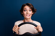 © deagreez - Photo portrait of pretty young girl nervous driving steering wheel wear trendy white outfit isolated on dark blue color background