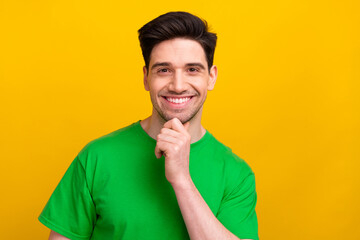 Poster - Photo portrait of handsome man wear green t shirt touching chin feels confident in business company isolated on green color background