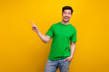 Sticker - Photo of excited smiling funny guy point finger empty space recommend new web design studio ad isolated on yellow color background