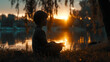 Kind sitzt am See und meditiert bei Sonnenuntergang