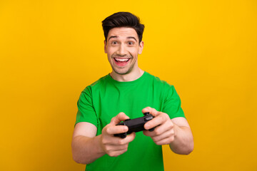 Sticker - Photo portrait of handsome young brunet guy play station promo dressed stylish green outfit isolated on yellow color background